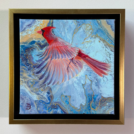 Framed artwork of a Northern cardinal bird on a blue and gold abstract background