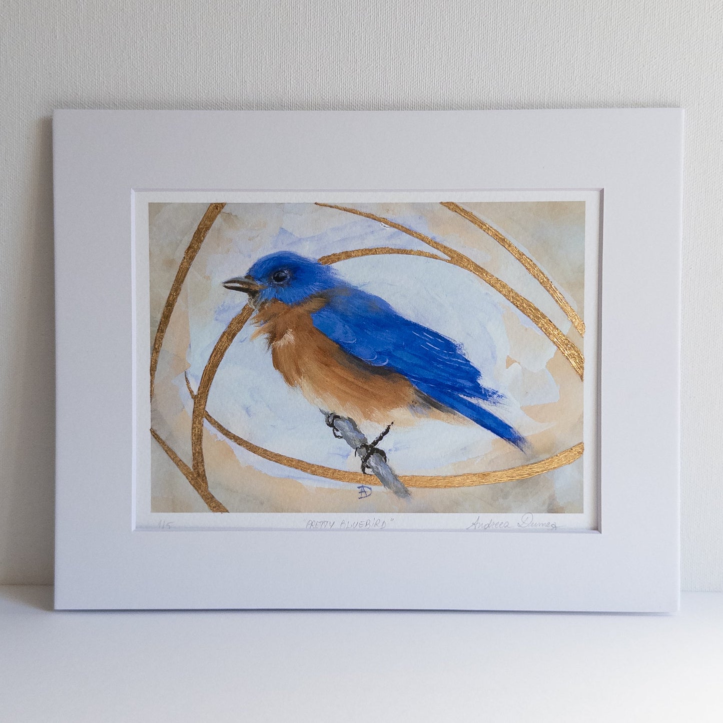 Framed artwork of a blue bird on a beige background