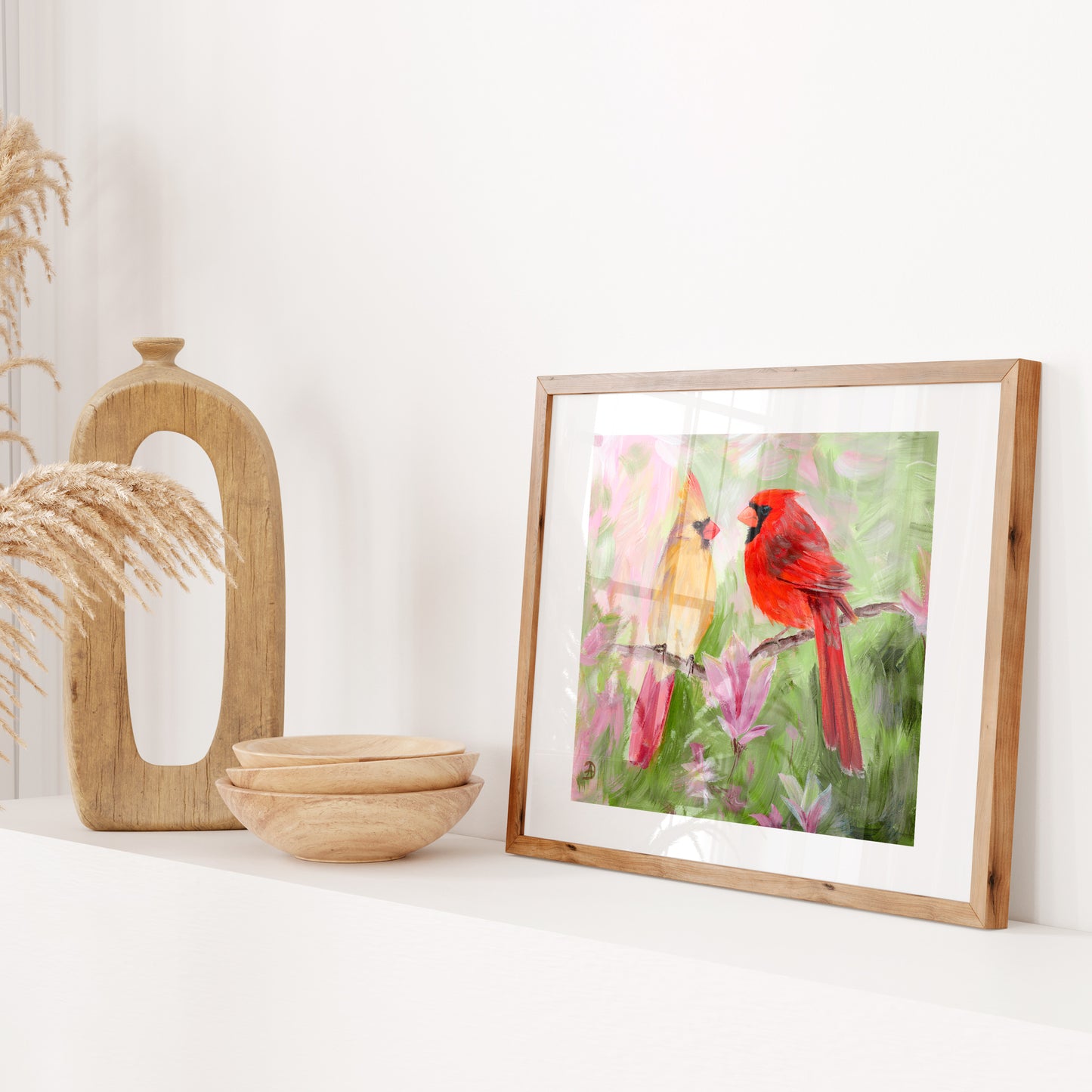 Framed painting reproduction of  a pair of cardinal birds on a magnolia branch, surrounded by magnolia flowers.