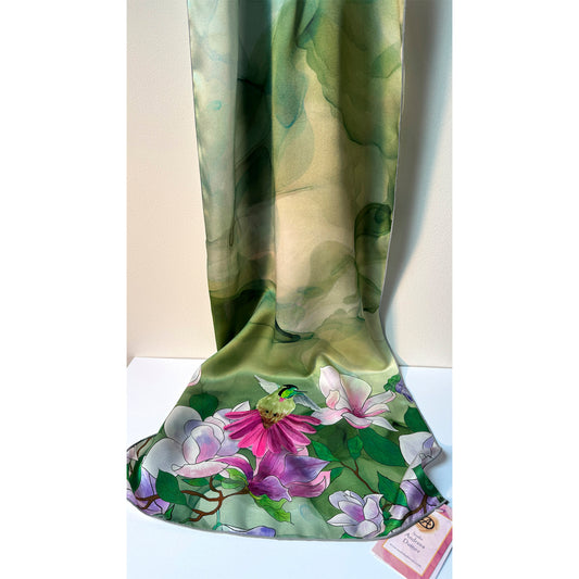 Floral patterned silk charmeuse scarf with pink and purple flowers and a hummingbird on a green background. Unique silk scarf suitable for client appreciation gifts and luxury corporate gifts. 