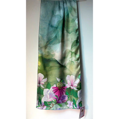 Floral patterned silk charmeuse scarf with pink and purple flowers and a hummingbird on a green background. Unique silk scarf suitable for client appreciation gifts and luxury corporate gifts. 