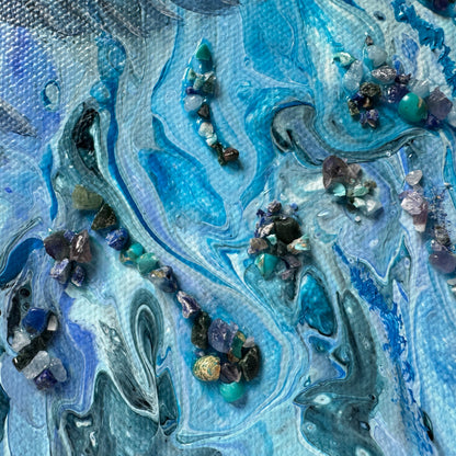 Artistic depiction of swirling blue and gray patterns with embedded stones