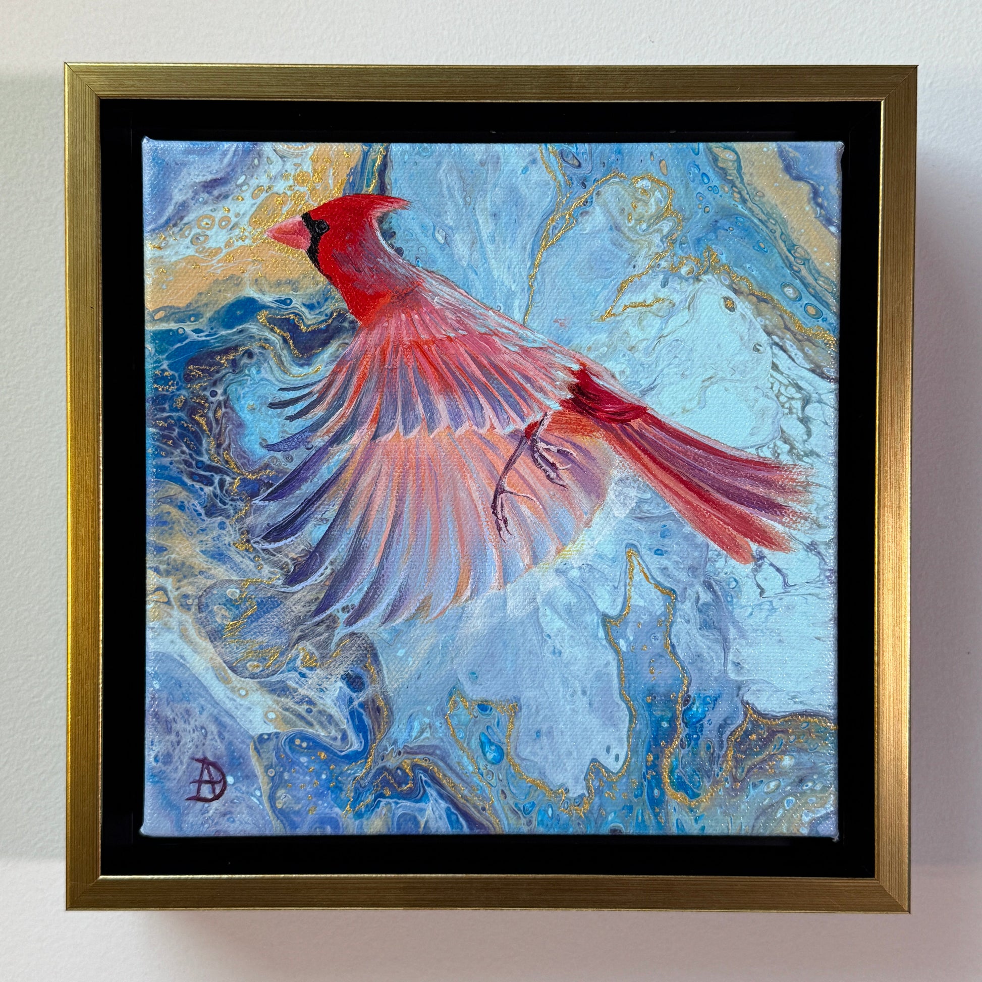 Framed artwork of a Northern cardinal bird on a blue and gold abstract background