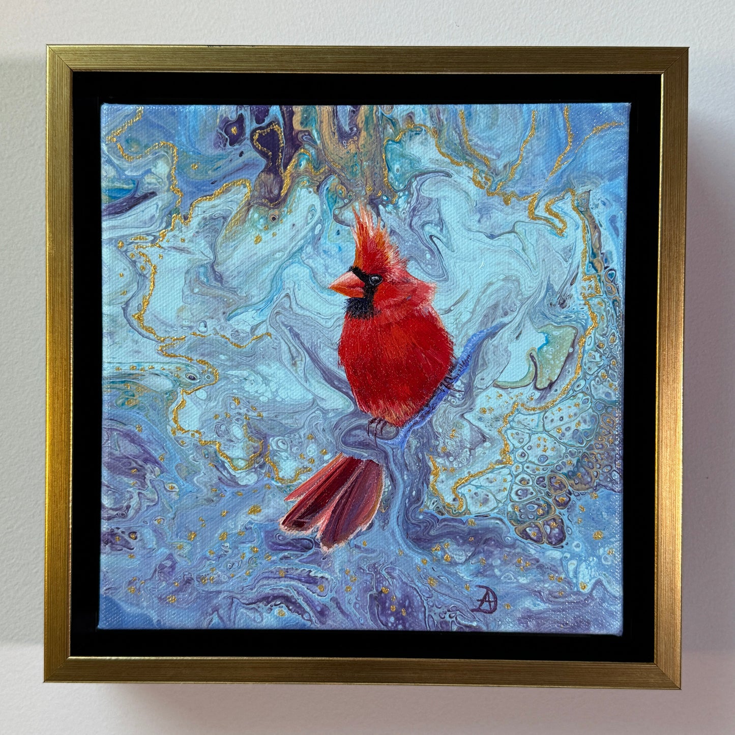 Framed artwork of a Northern Cardinal on a blue and gold abstract background