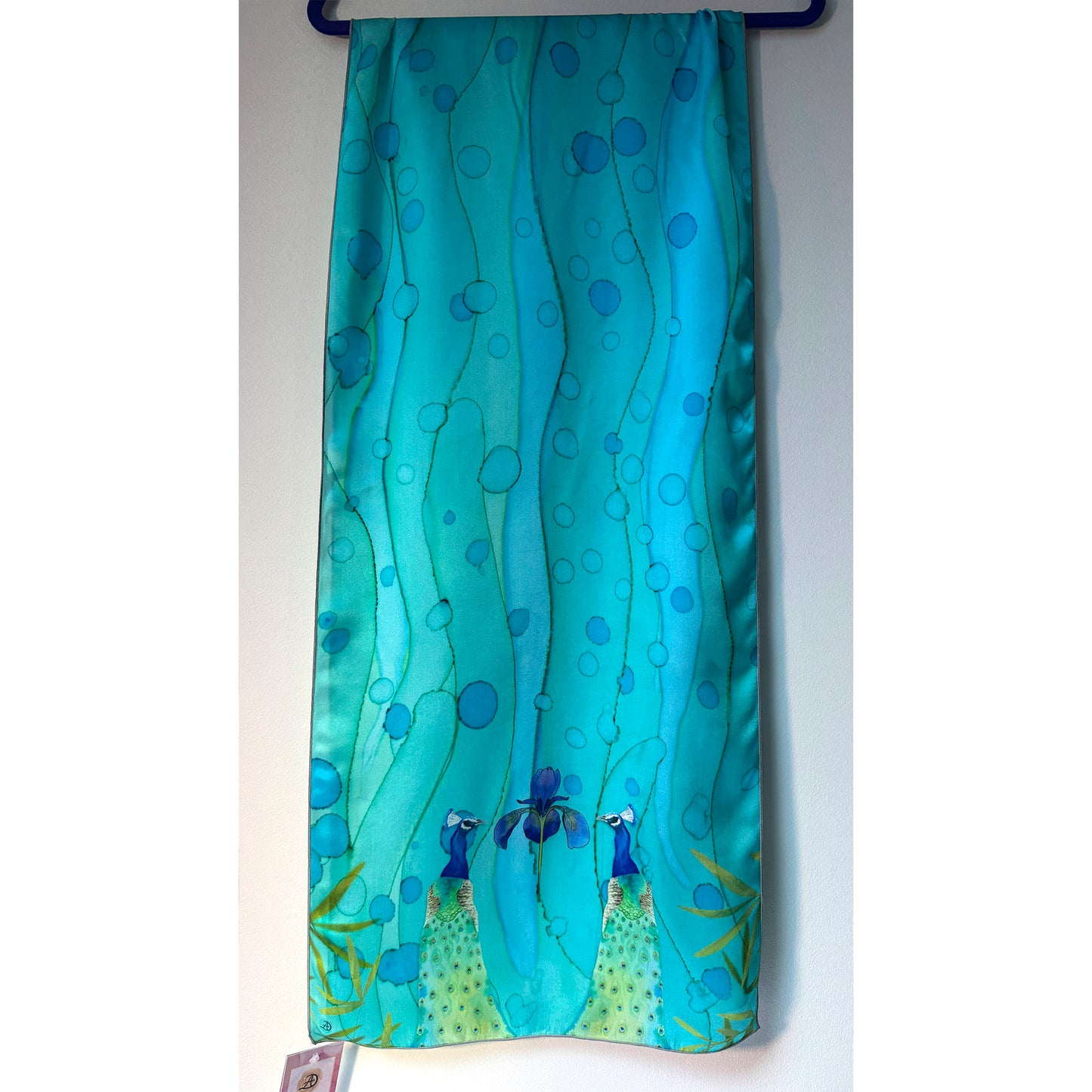 Teal-colored scarf with peacock design on a white background. Unique silk scarf suitable for client appreciation gifts and luxury corporate gifts. 