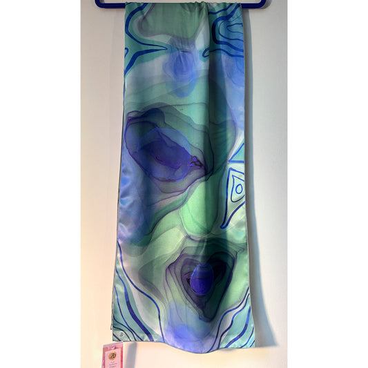 Colorful scarf with abstract peacock eye patterns on a white background. Unique silk scarf suitable for client appreciation gifts and luxury corporate gifts. 