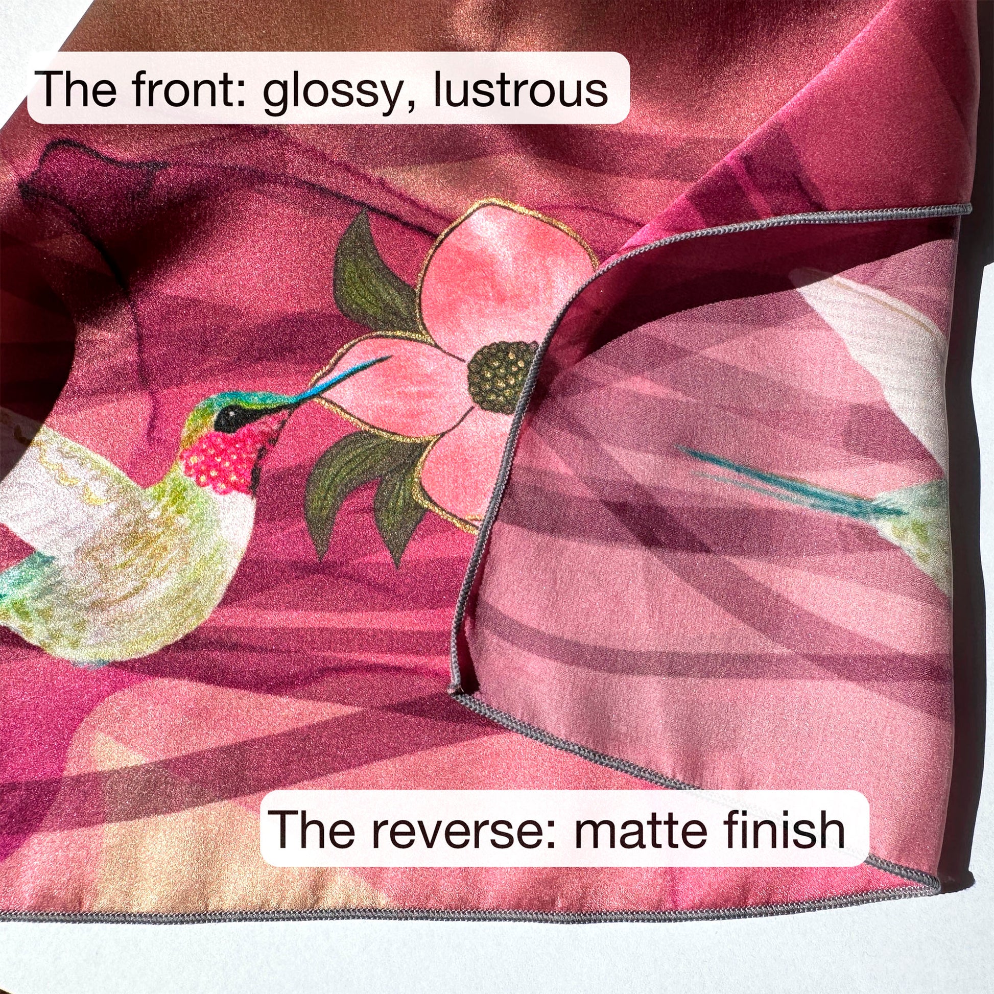 Silk fabric with a hummingbird and flower design on one side and a plain finish on the other, labeled 'glossy, lustrous' and 'matte finish'.