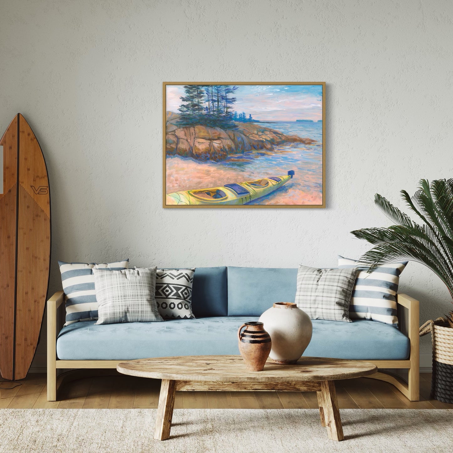 Coastal interior with an art print depicting a seascape with a rocky seashore and a yellow kayak, overlooking the islands at Acadia National Park. 