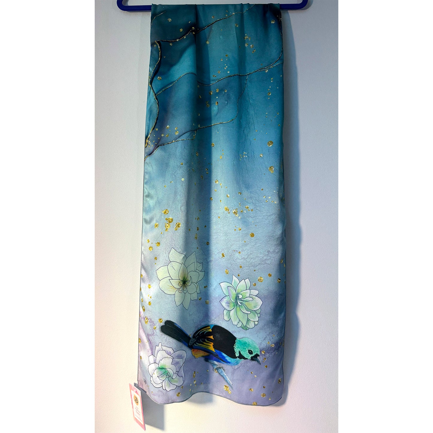 Blue silk scarf with floral and exotic bird design on a white background. Unique silk scarf suitable for client appreciation gifts and luxury corporate gifts. 